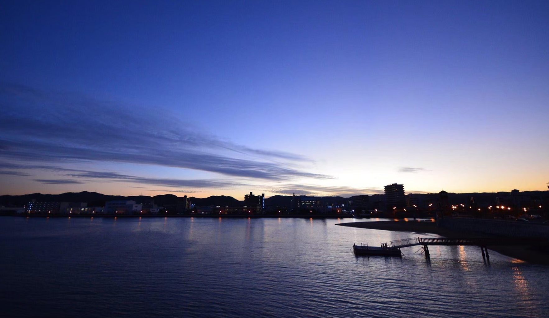 The sea and town lights at dusk