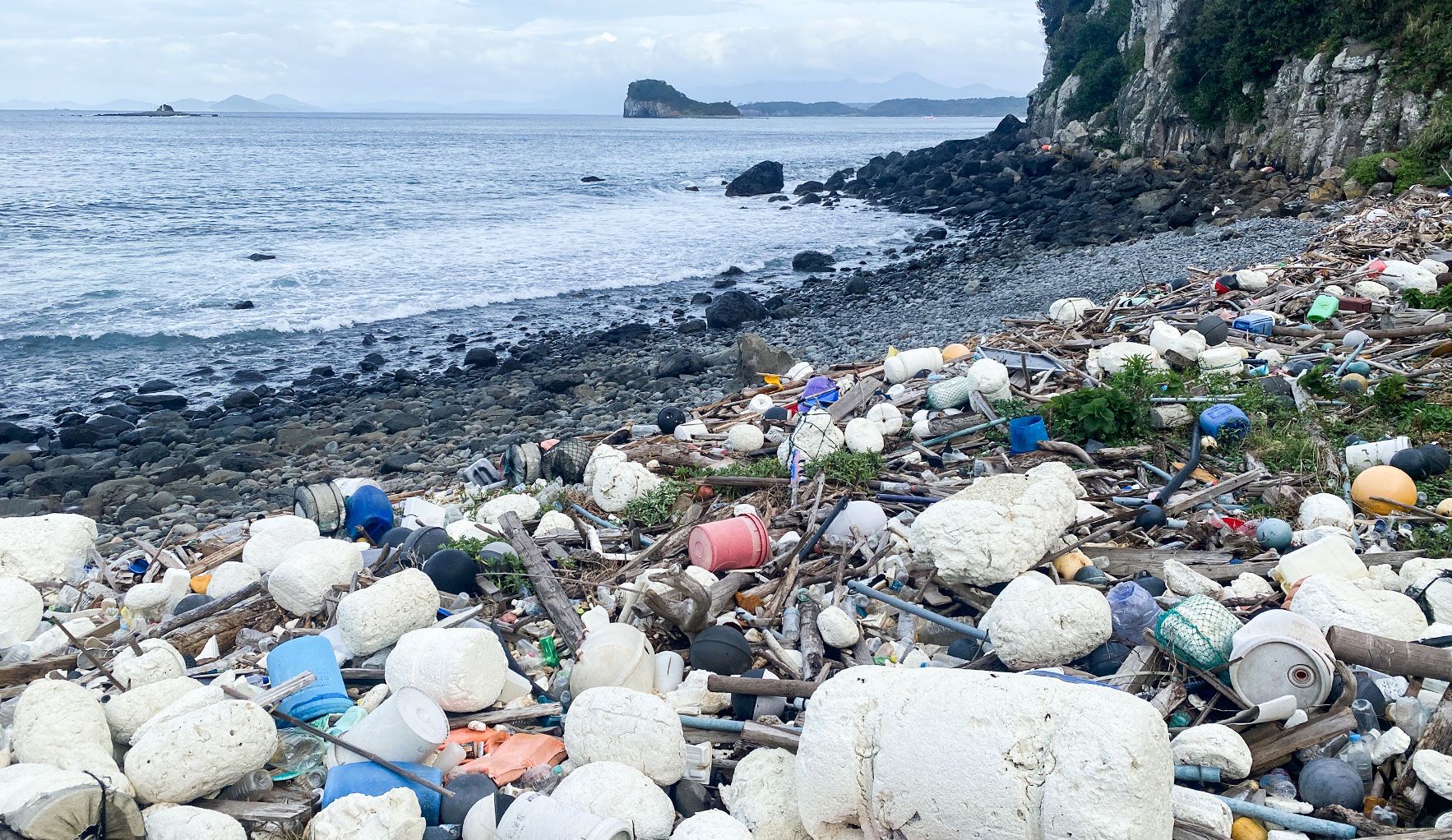 Marine litter washed up on a rocky shore